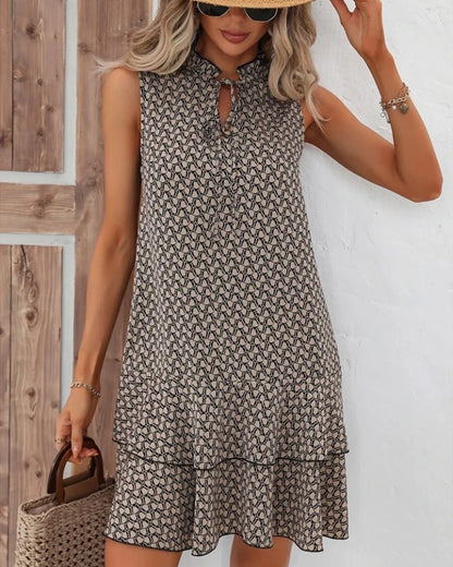 Mouwloze midi jurk met strikceintuur en gelaagde zoom in zwart beige