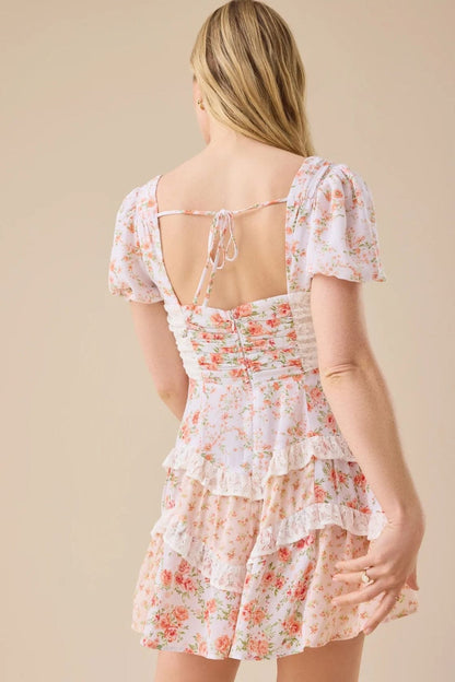 Minijurk met bloemmotief, kanten patchwork, V-hals en pofmouwen